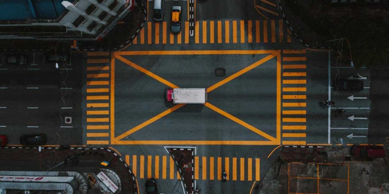 High-angle aerial view of a busy intersection in Ipoh, Malaysia, showcasing urban road layout.