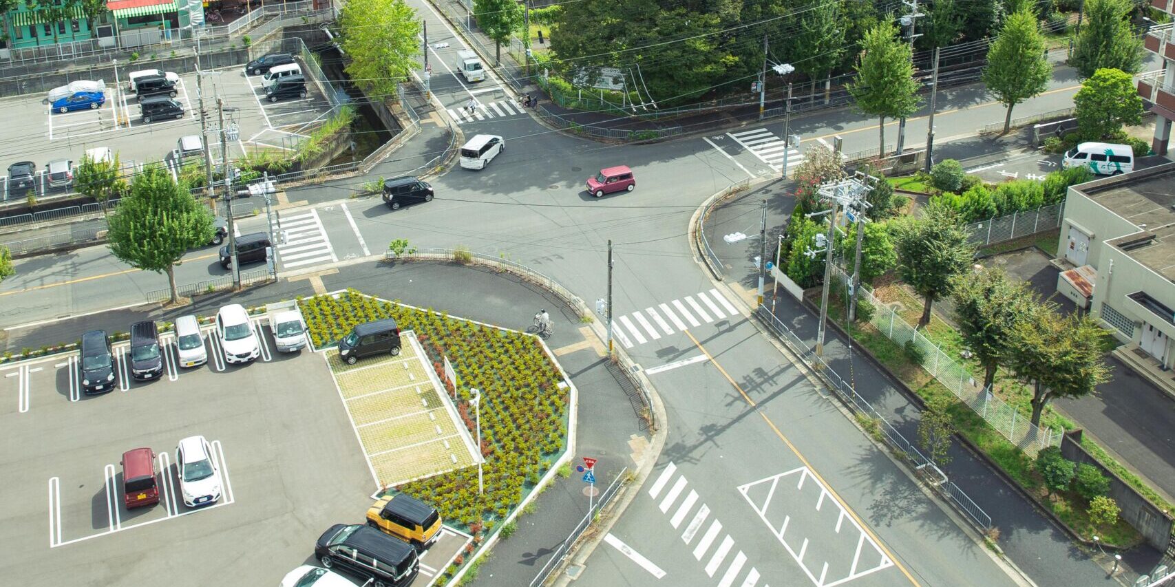 Aerial shot of a tranquil Japanese urban residential area with lush greenery and modern architecture.